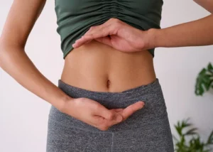 Woman in exercise outfit showing midriff signaling gut health
